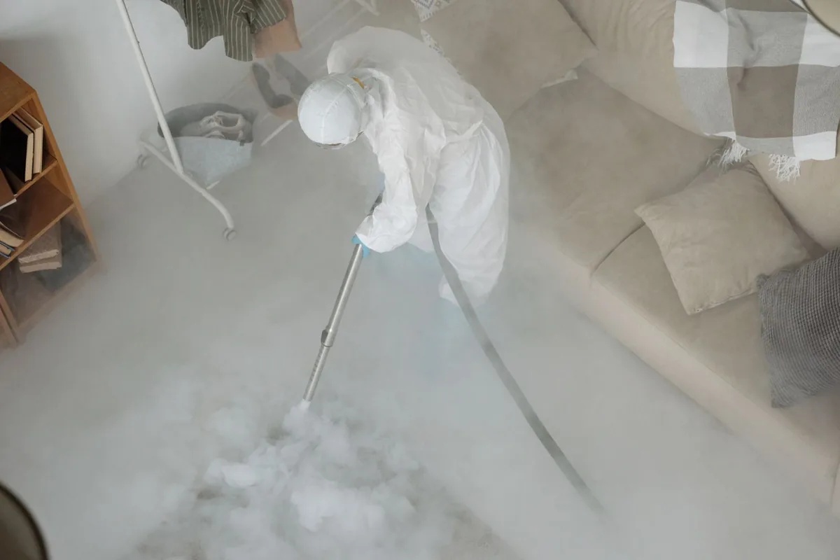 Biohazard cleanup technician in protective equipment, Sheridan, AR